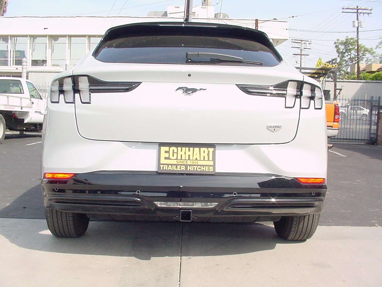 Custom hidden trailer hitch installed on a Mustang Mach E electric luxury SUV by the Eckharts 