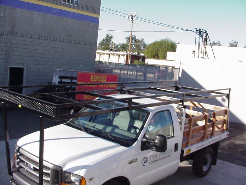 Custom-welded heavy-duty utility rack on a commercial stake bed truck.