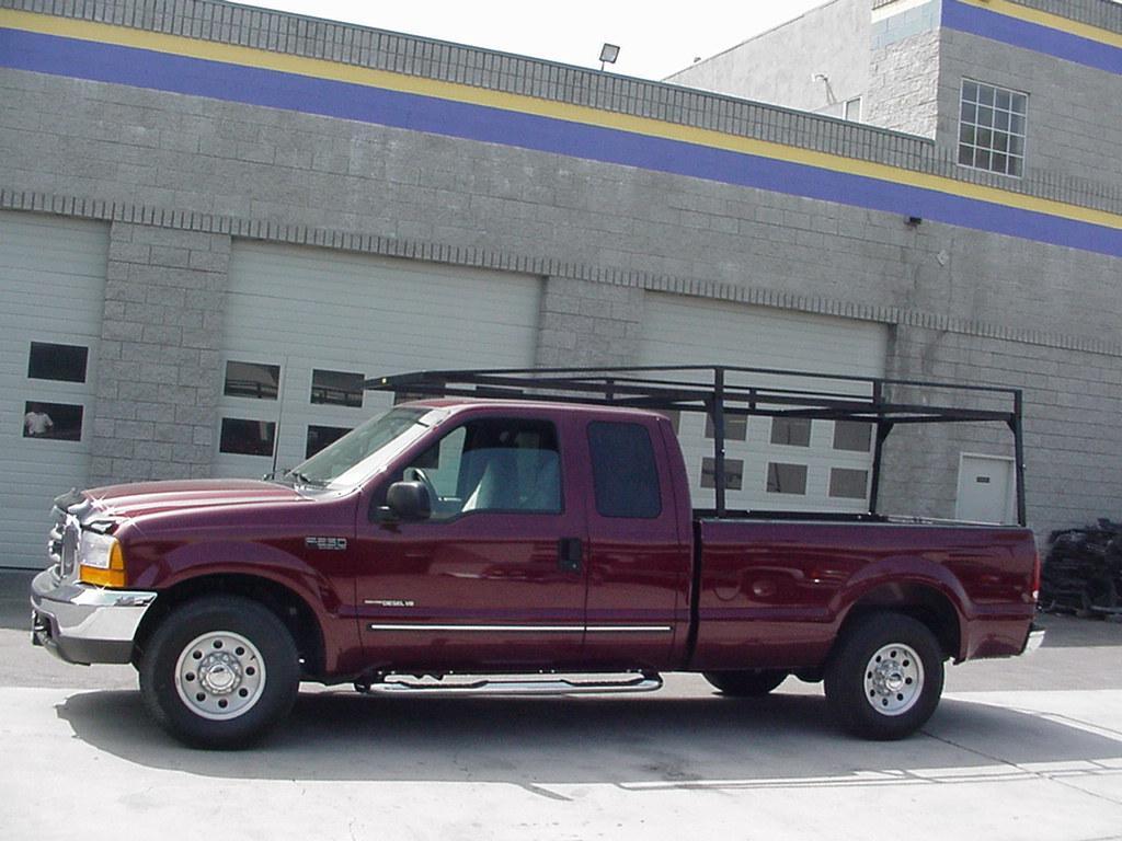 Custom-welded heavy-duty lumber rack installed on a Ford pickup truck.